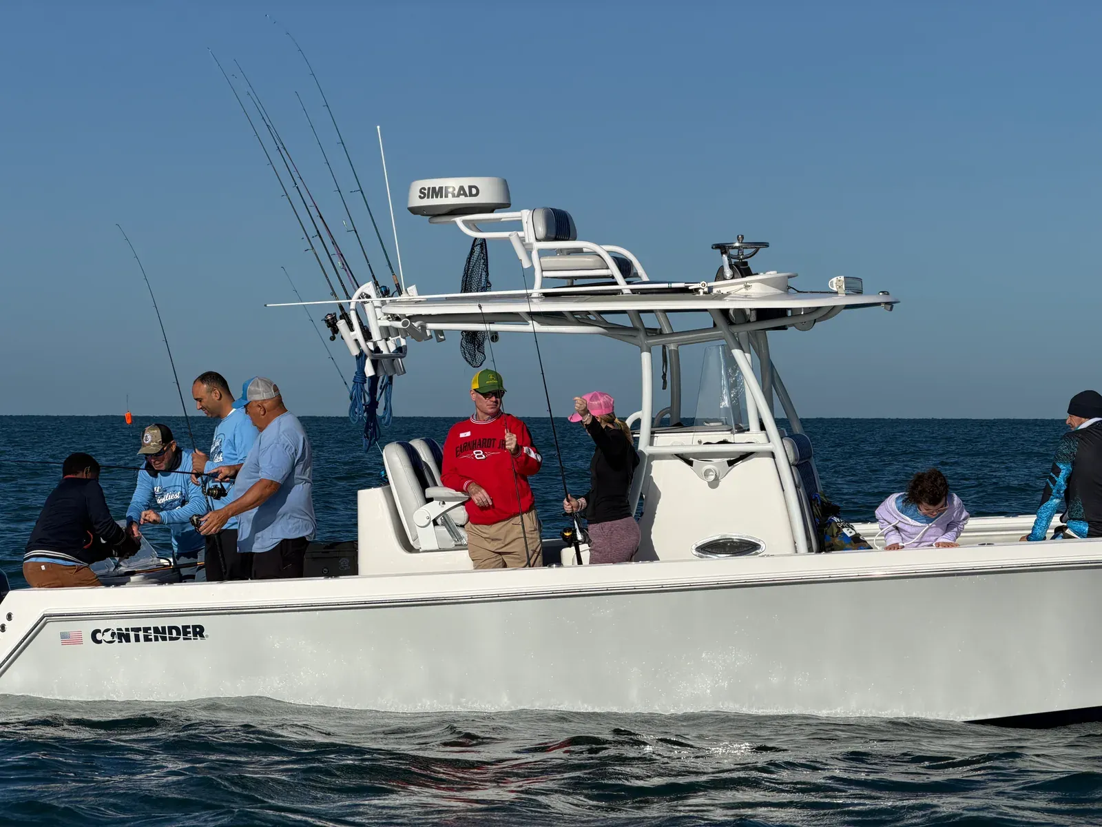 Guests and volunteers fishing together at Friendliest Catch Fishing Fun Day — Sarasota Bay, October 20, 2026.