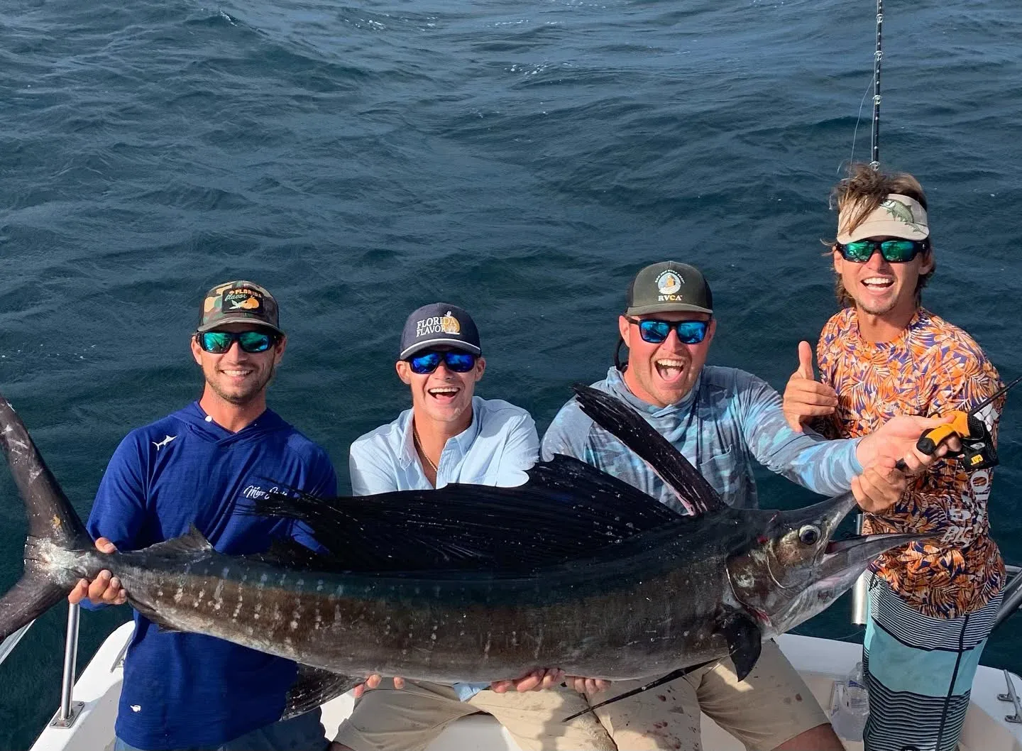 Group of anglers with a trophy sailfish during a Sarasota custom fishing charter.