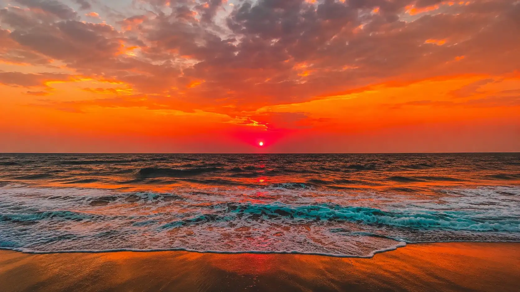 Brilliant sunset over the Gulf of Mexico near Sarasota during an evening sunset cruise with colorful skies and rolling waves.