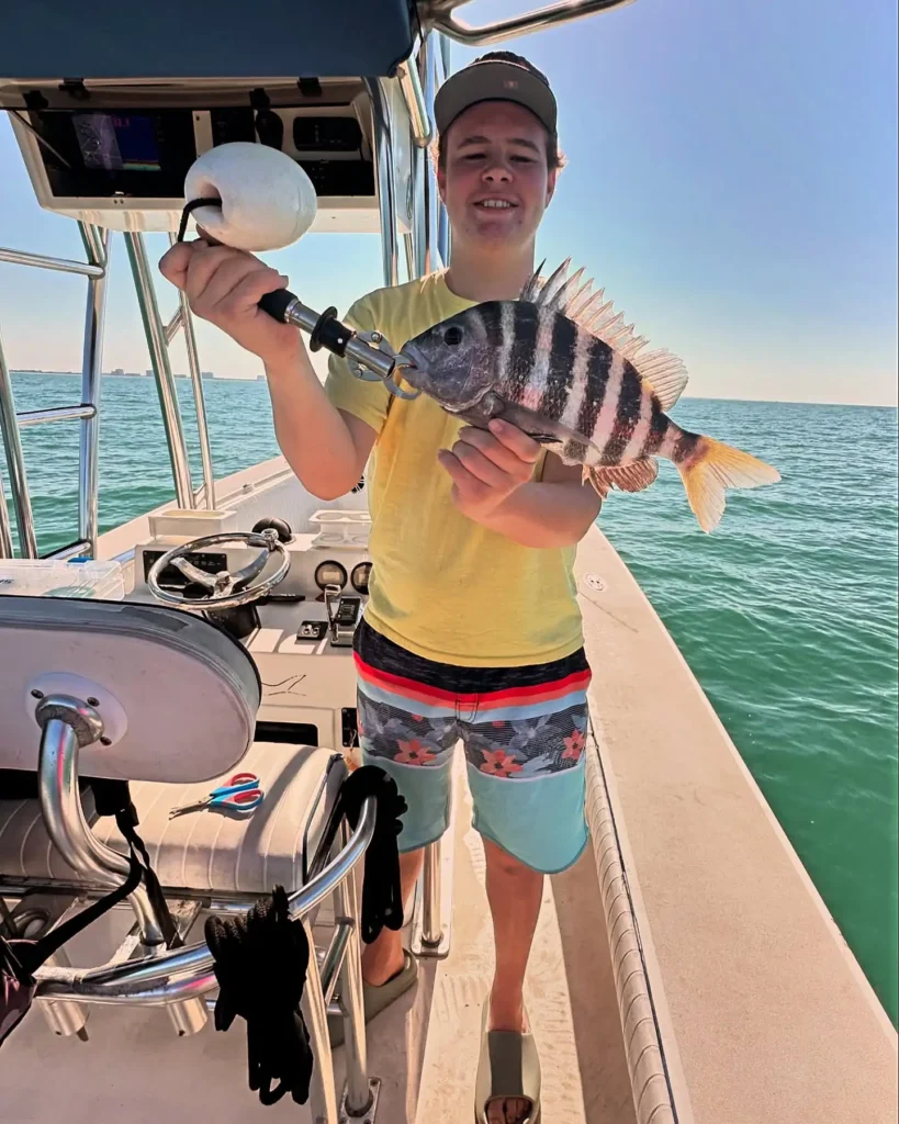 Boy holding a sheepshead during a Sarasota fishing charter.
