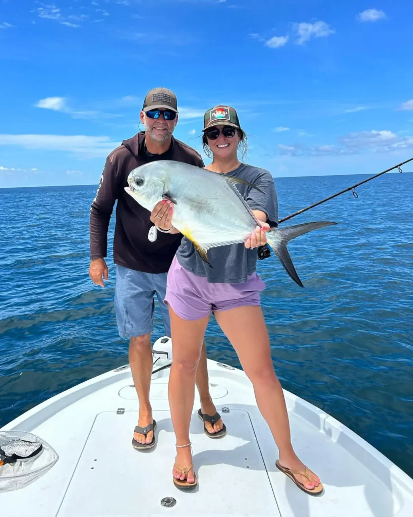 Woman holding a permit during an offshore Sarasota fishing charter.