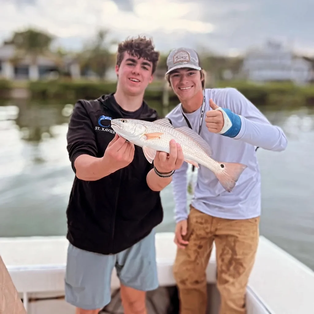 Young angler with a redfish on a Sarasota inshore fishing charter.