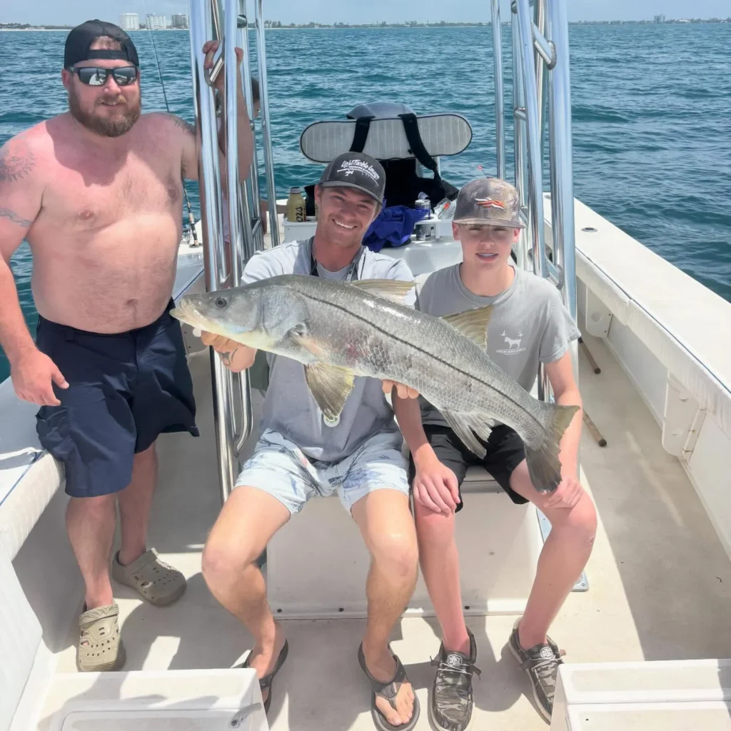 Family with a snook caught during a Sarasota inshore fishing charter.