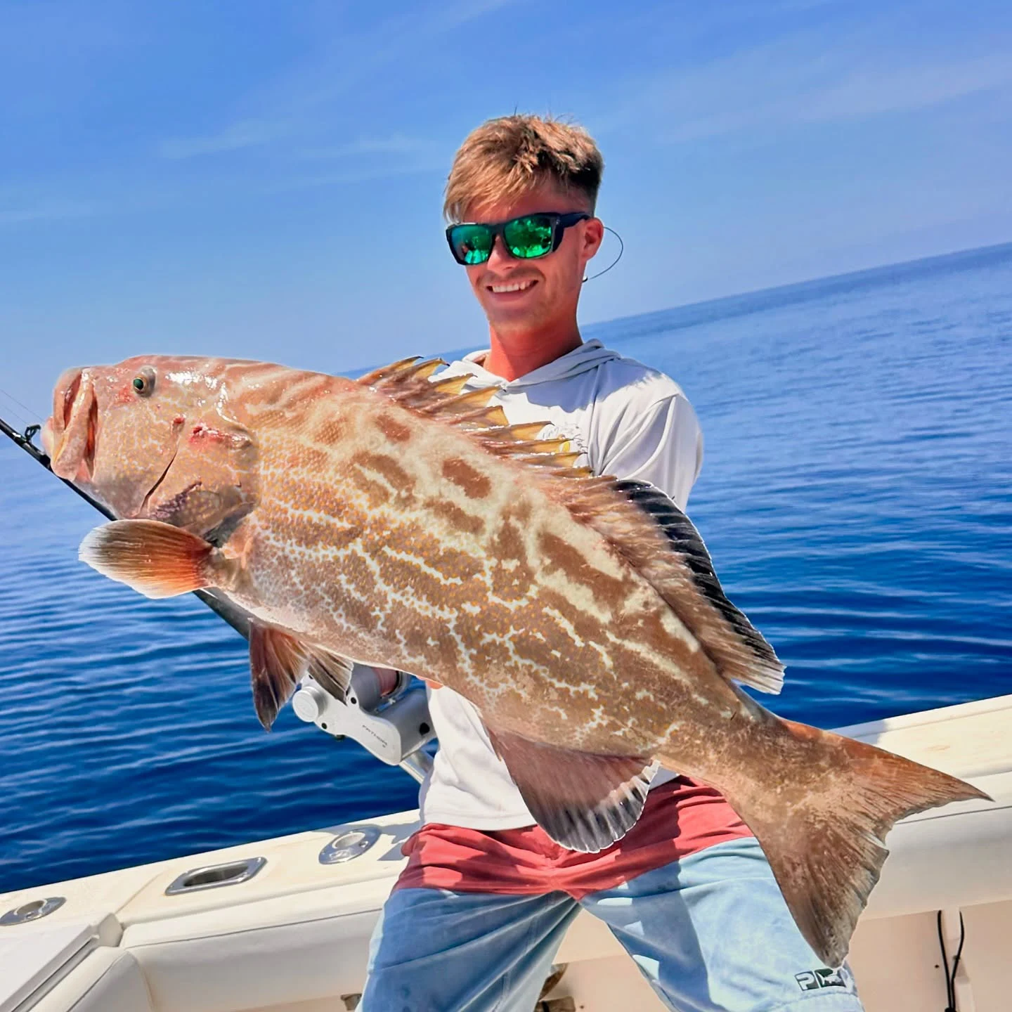 Angler holding a gag grouper caught during a Sarasota nearshore fishing charter.
