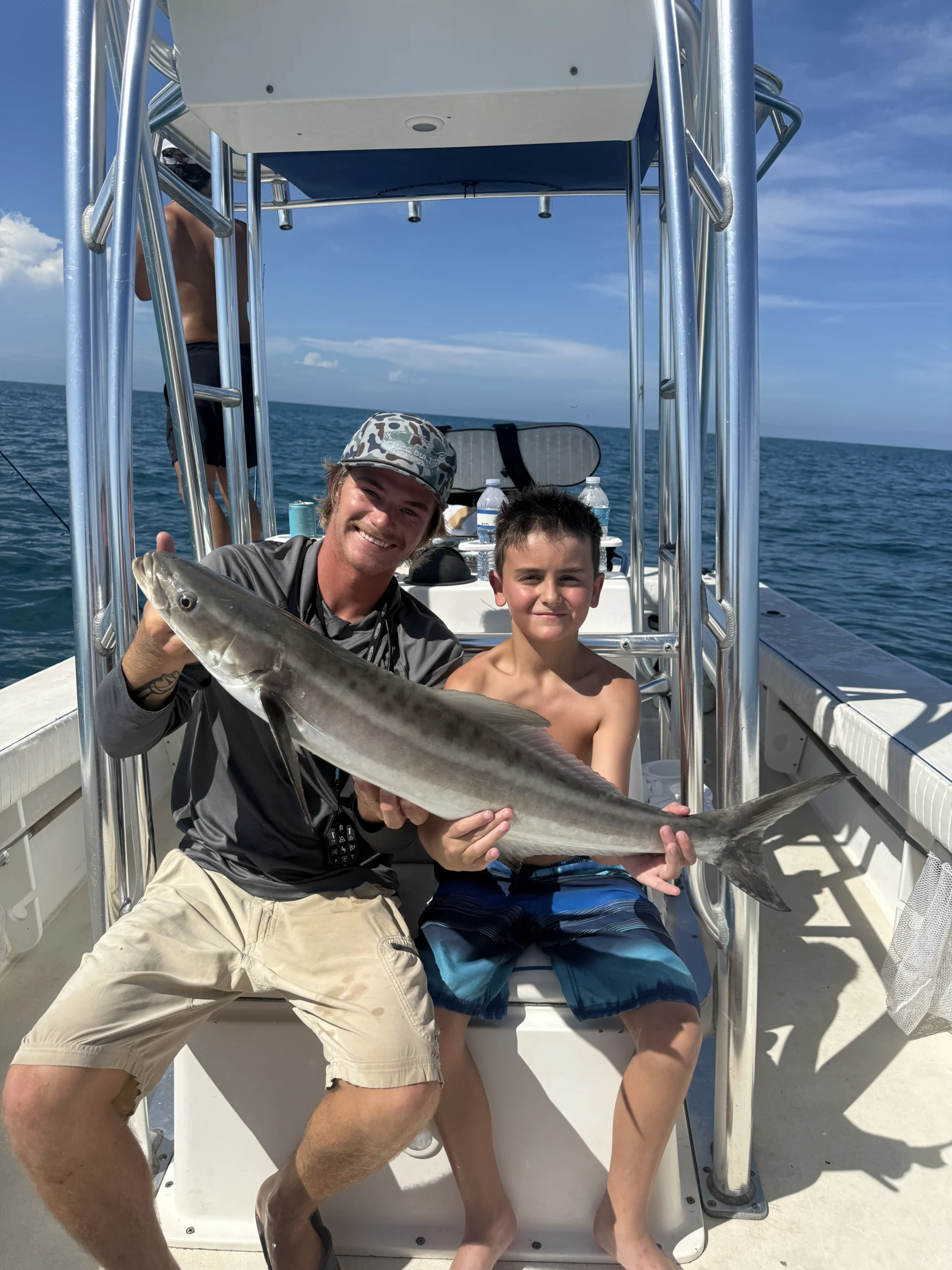 Captain and young angler holding a cobia during a successful nearshore fishing trip in Sarasota, Florida.